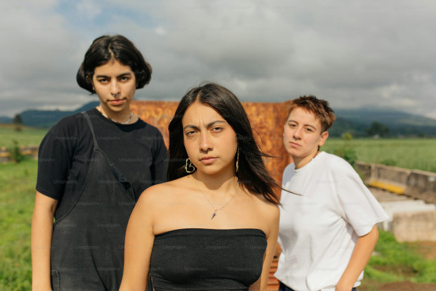 Couple facing each other with an onlooker showing interest in one partner, highlighting the impact of unwanted attention on relationships